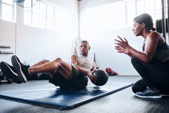 man exercising with trainer