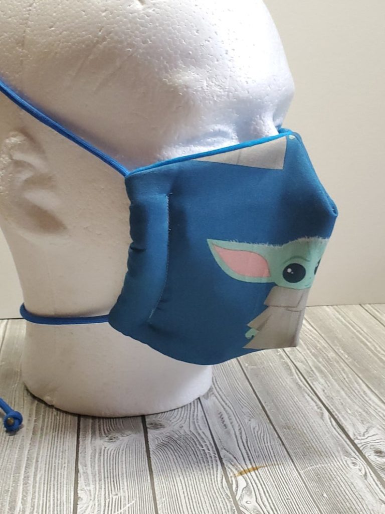 This Baby Yoda face mask from Nerdy Bird Co. comes with adjustable pull-ties for extra comfort.