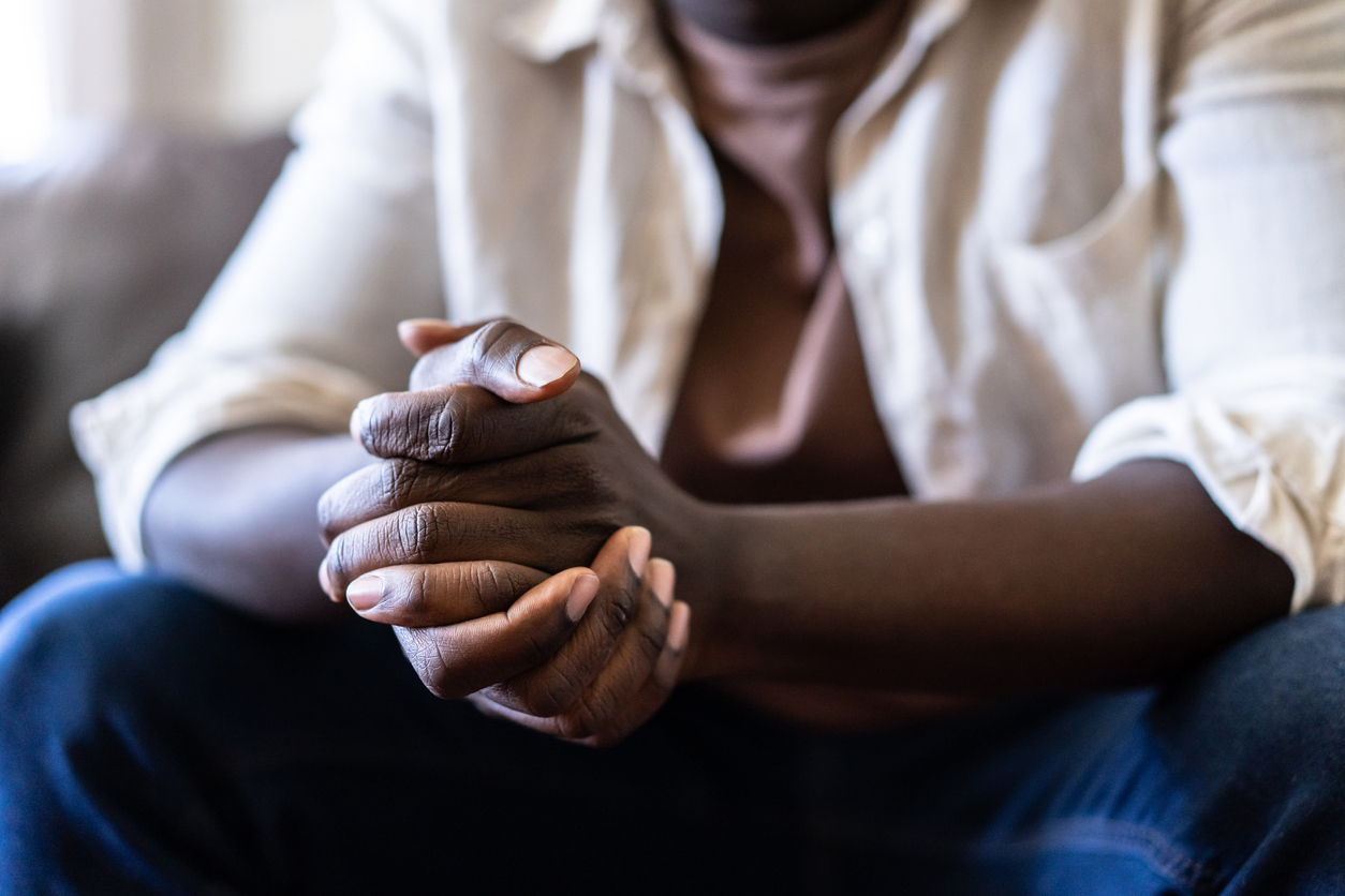 man with folded hands sitting