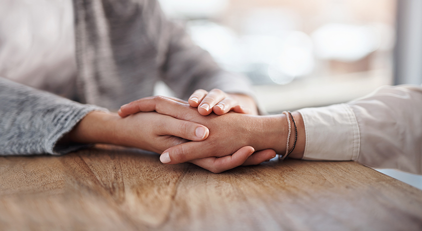 Two people holding hands